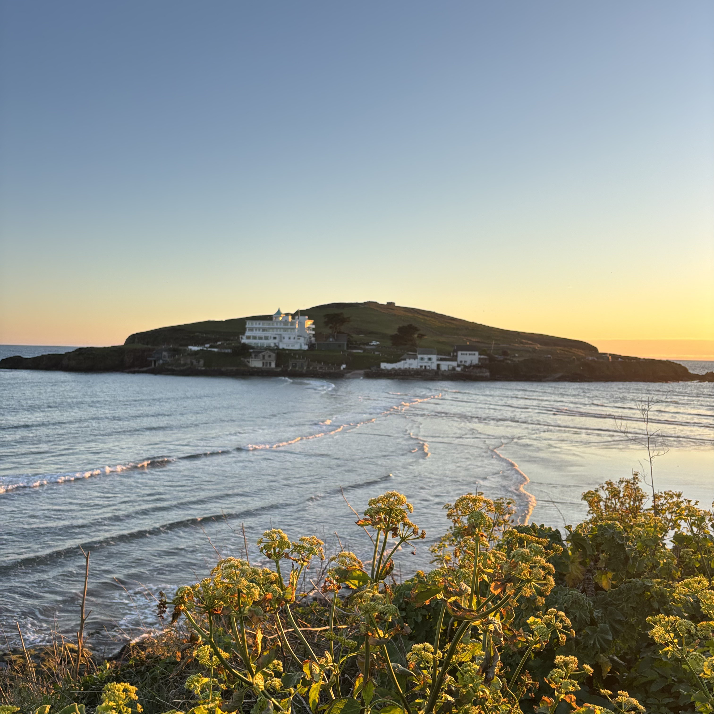 Open water swimmers in Bigbury Bay with Burgh Island in the distance